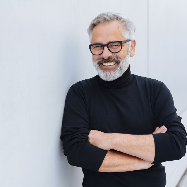 senior man with glasses smiling