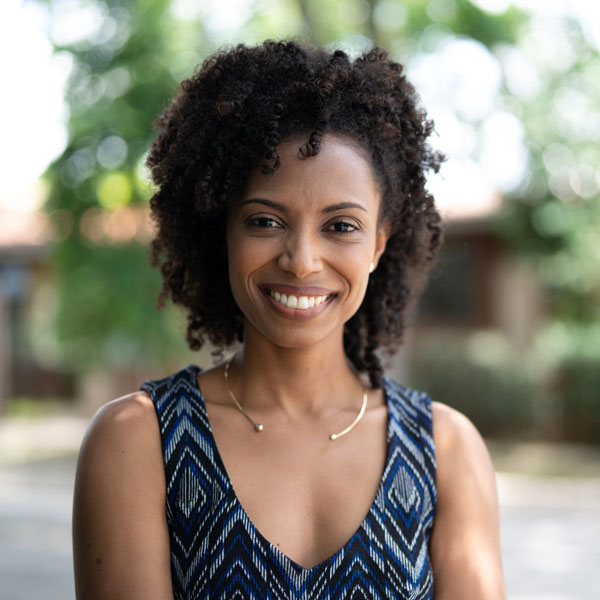 A smiling Black woman with curly hair radiates Restorative Dentistry in Flagstaff and Cottonwood, AZ.