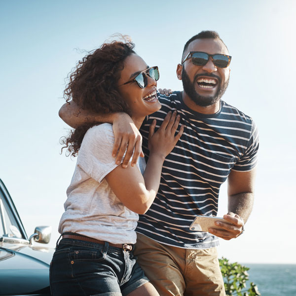 young adult couple smiling outdoors