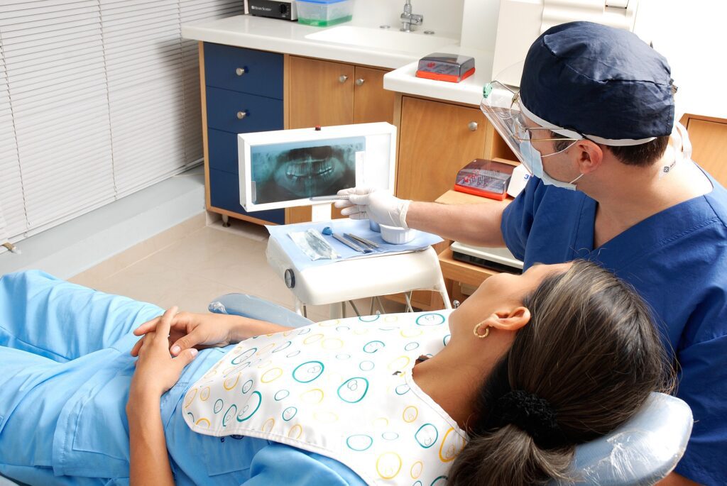 dentist showing patient x-ray